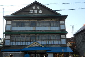駅の目の前にある木造三階建て旅館・富田屋
